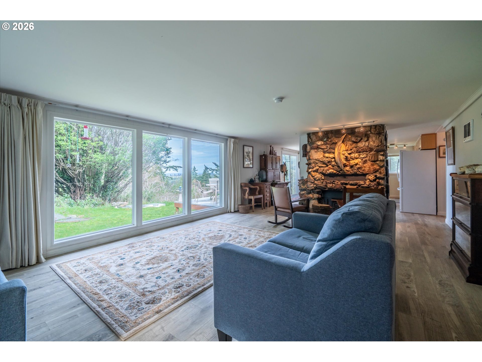 42528 Hensley Hill Road Port Orford, OR 97465 - Photo 2 of 37 a living room with furniture and a floor to ceiling window