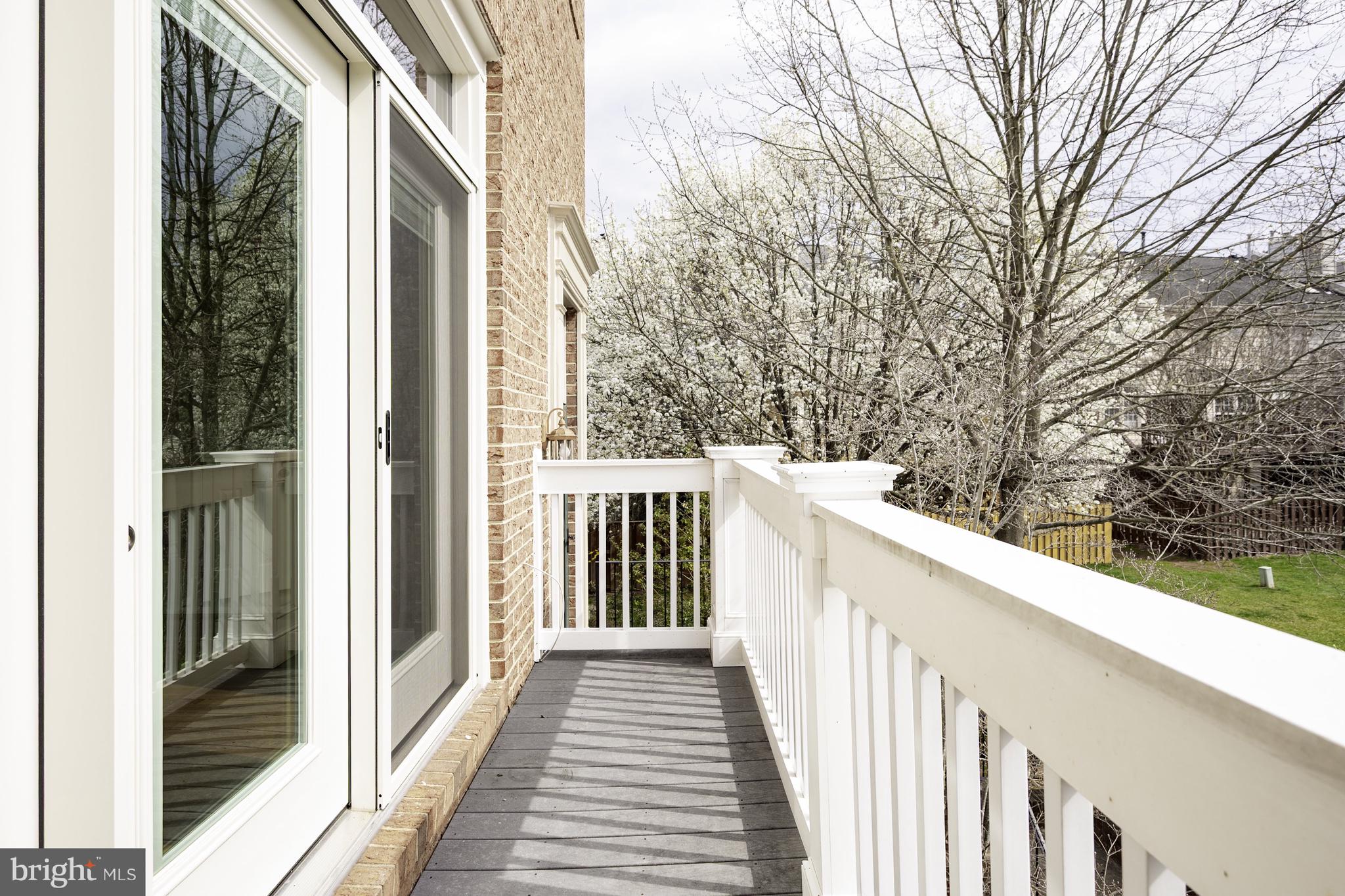 20334 Burnley Square Sterling, VA 20165 - Photo 12 of 57 a view of a balcony with wooden floor and fence