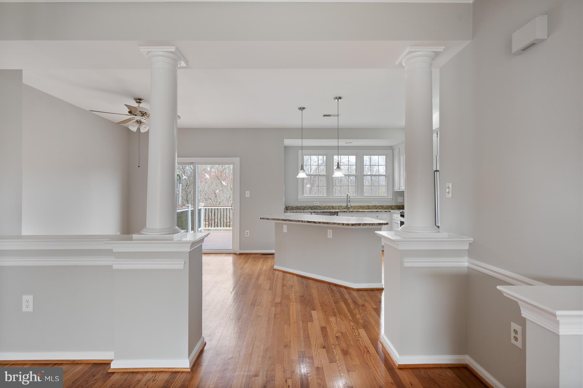 20334 Burnley Square Sterling, VA 20165 - Photo 14 of 57 a kitchen with kitchen island white cabinets and stainless steel appliances