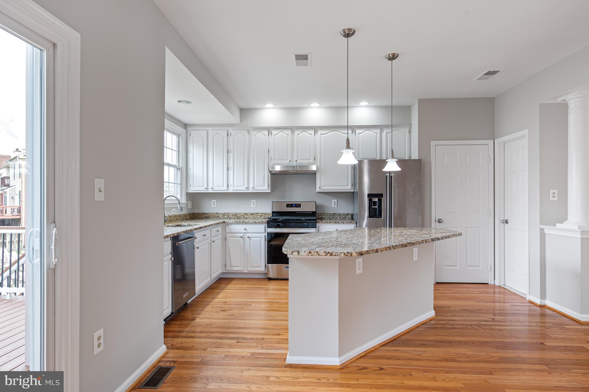 20334 Burnley Square Sterling, VA 20165 - Photo 16 of 57 a kitchen with kitchen island stainless steel appliances a stove and a refrigerator