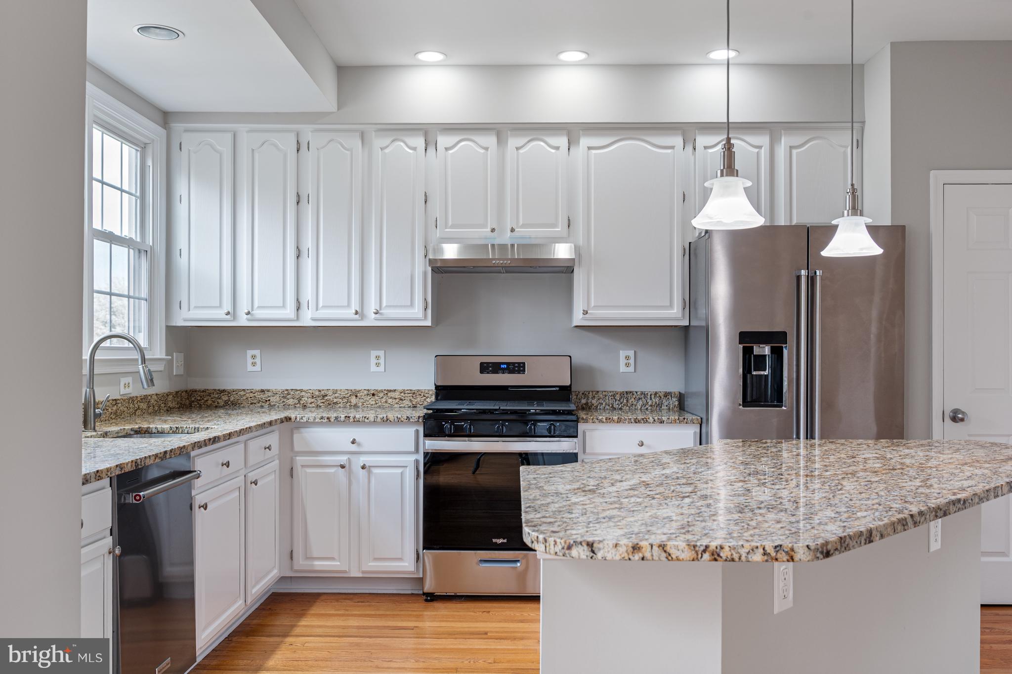 20334 Burnley Square Sterling, VA 20165 - Photo 18 of 57 a kitchen with stainless steel appliances granite countertop a stove sink and cabinets