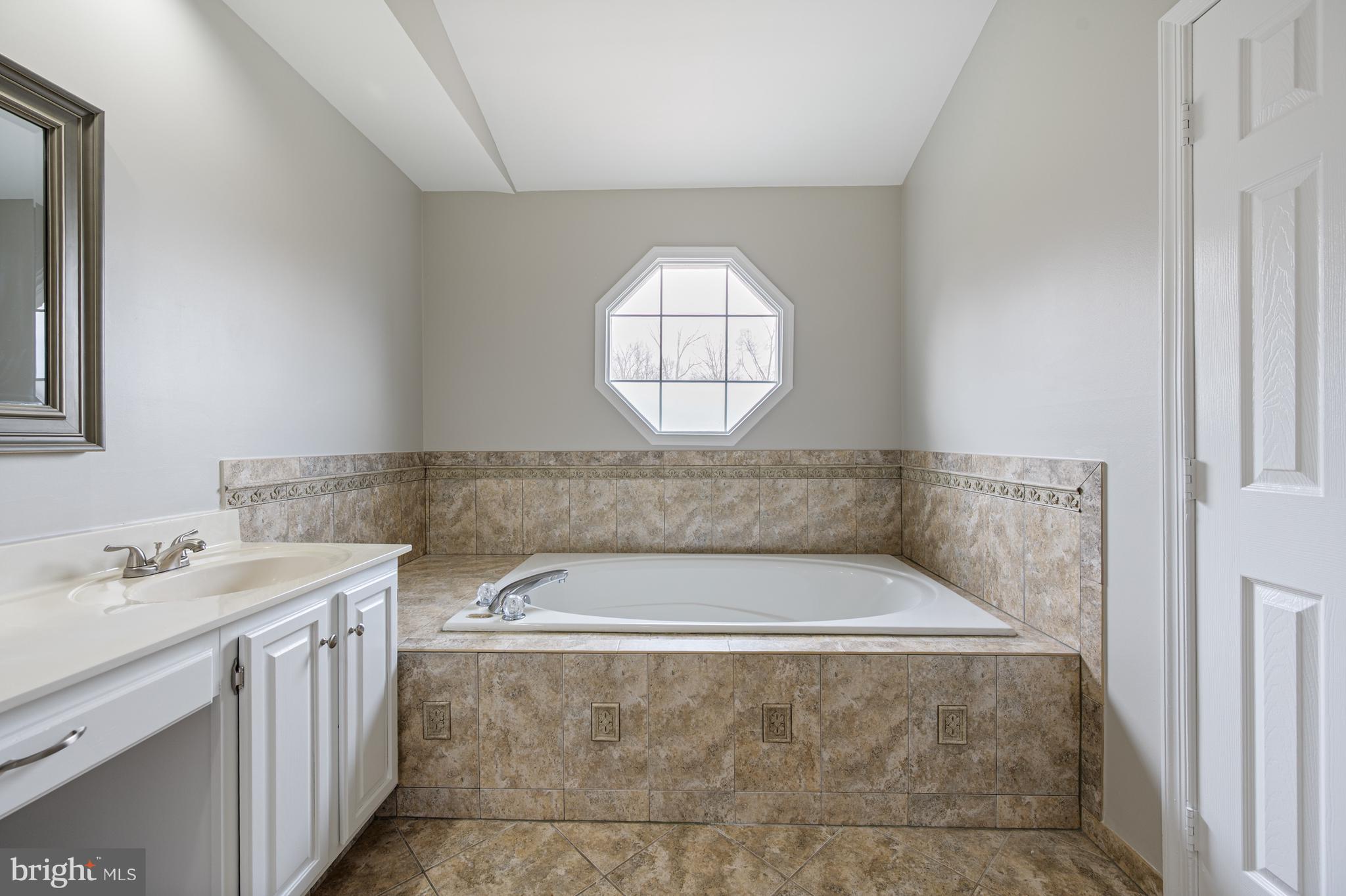 20334 Burnley Square Sterling, VA 20165 - Photo 29 of 57 a bathroom with a bathtub and a sink