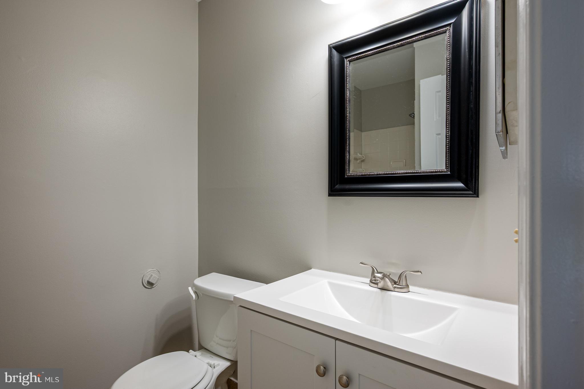 20334 Burnley Square Sterling, VA 20165 - Photo 39 of 57 a bathroom with a toilet sink and mirror