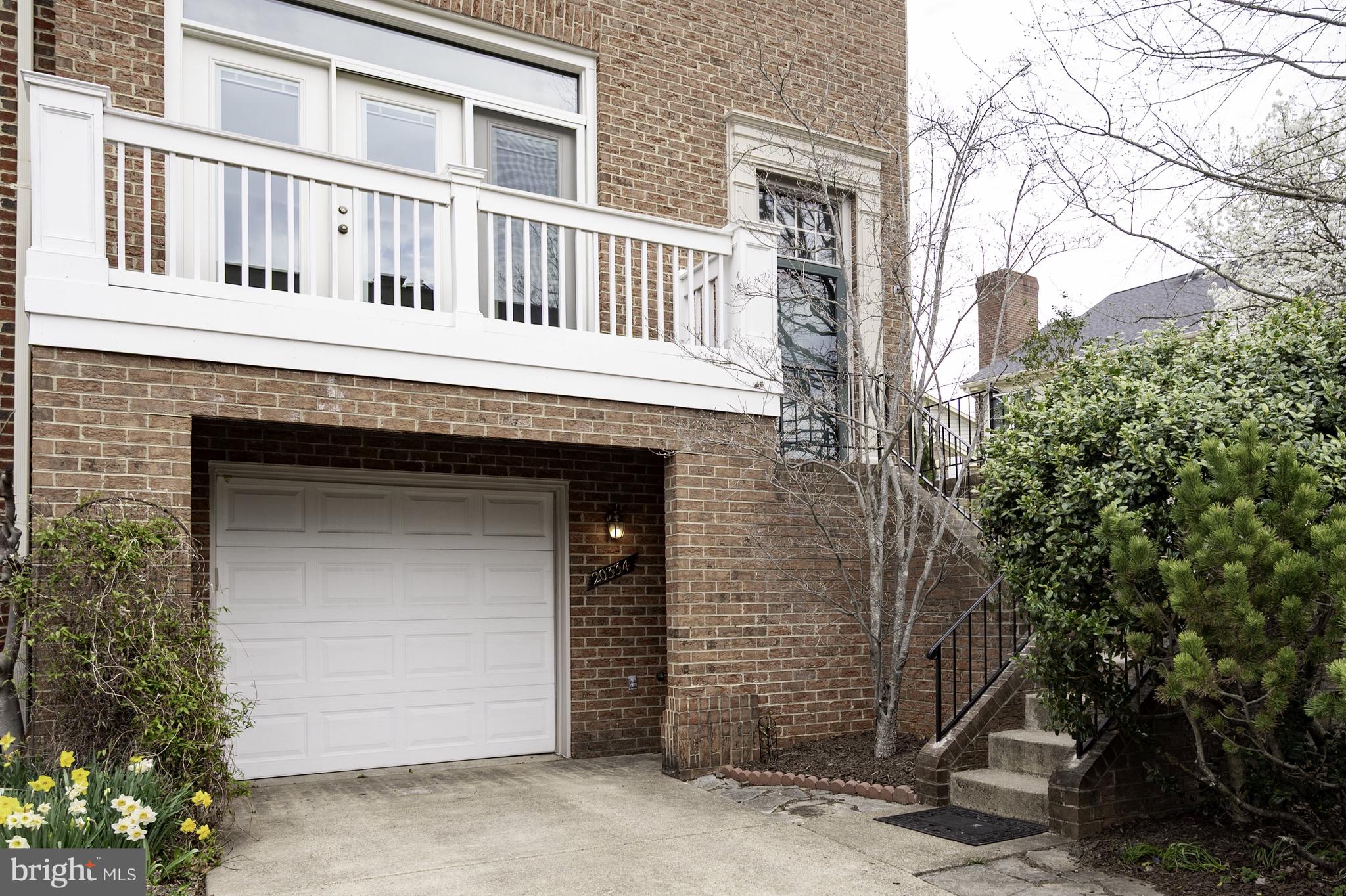 20334 Burnley Square Sterling, VA 20165 - Photo 5 of 57 a front view of a house with a garage