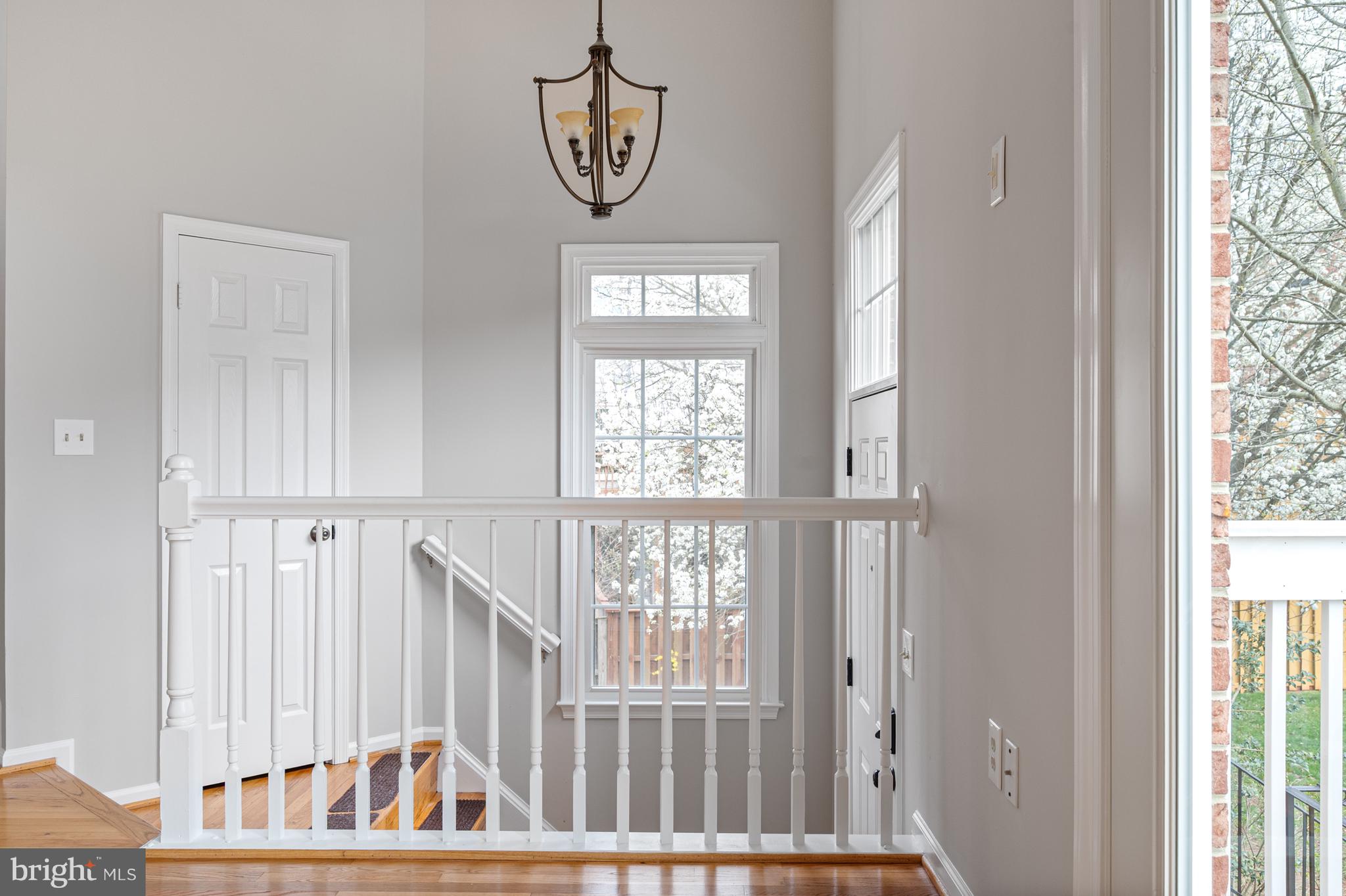 20334 Burnley Square Sterling, VA 20165 - Photo 6 of 57 a view of a hallway with wooden floor and windows