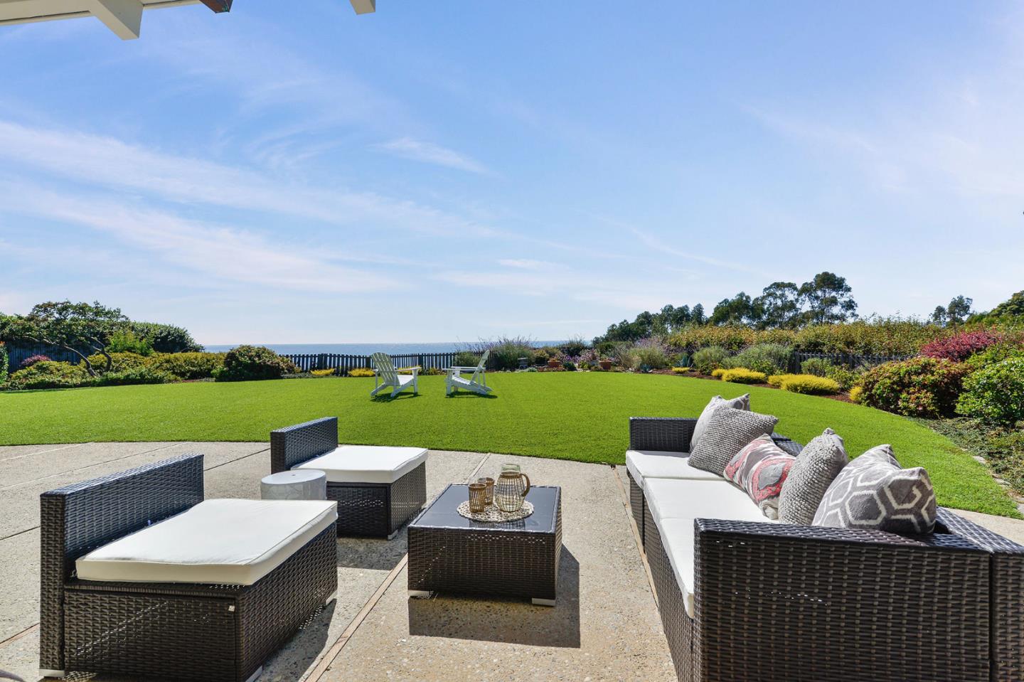 532 Bayview Drive Aptos, CA 95003 - Photo 29 of 47 a view of a patio with couches chairs potted plants and a lake view