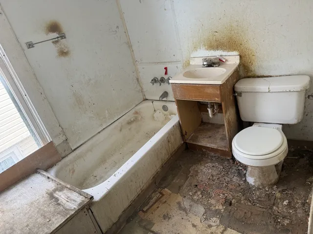 a white toilet sitting next to a bathroom sink