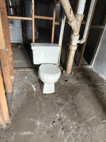 a white toilet sitting next to a sink