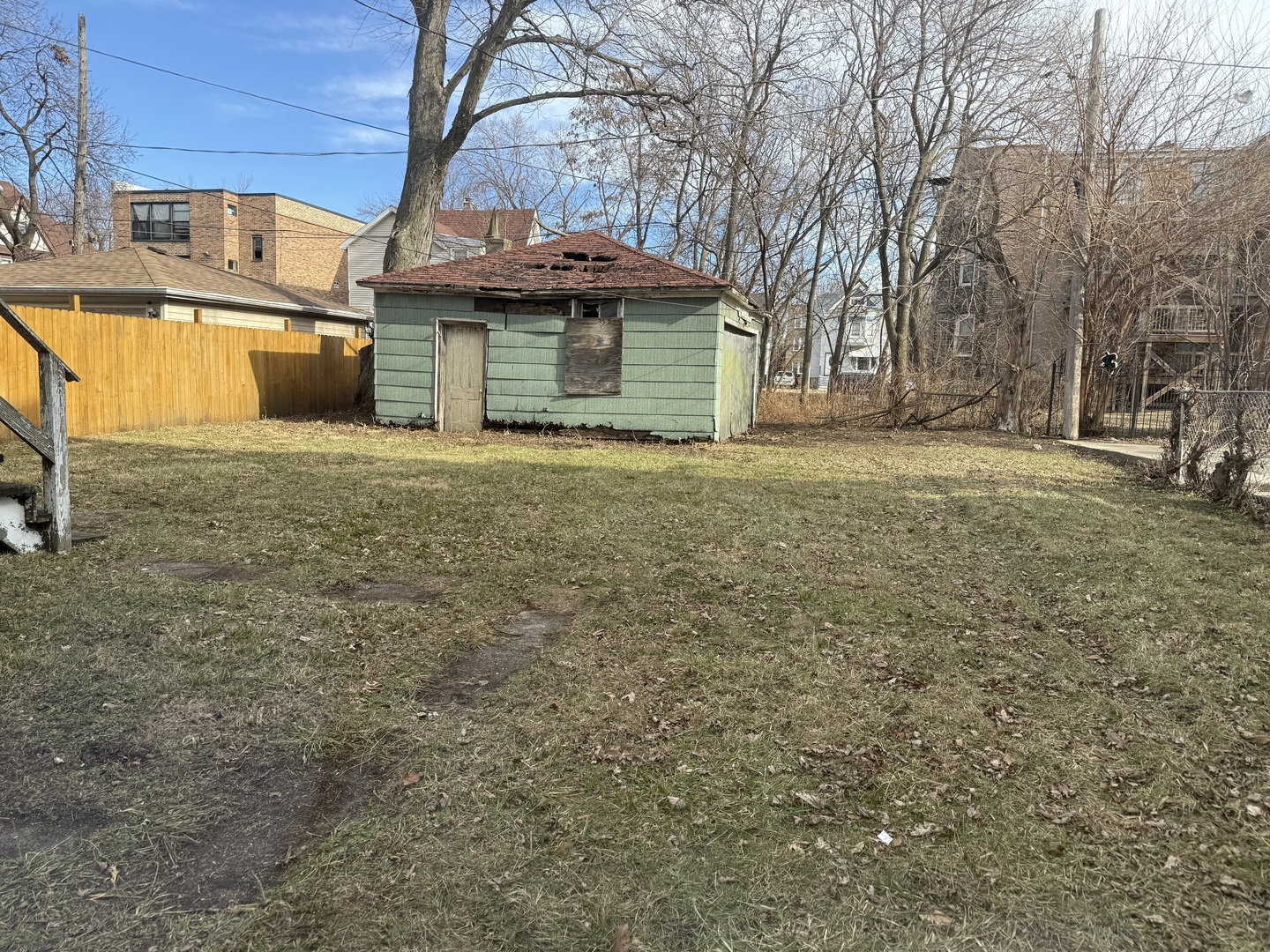 6951 South Princeton Avenue Chicago, IL 60621 - Photo 25 of 25 a view of a house with a yard and table and chairs under an umbrella