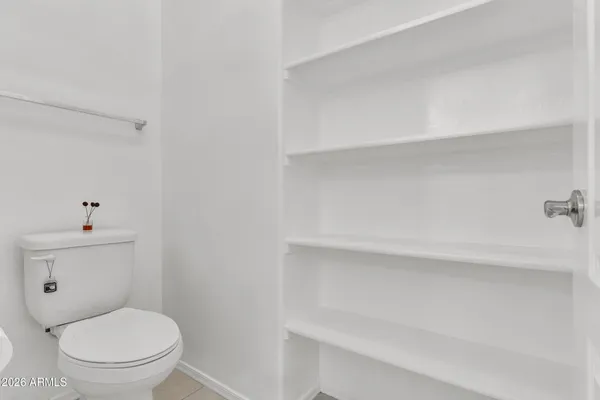 a white toilet sitting next to a bathroom sink