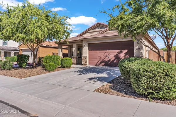 a front view of a house with a yard and a garage
