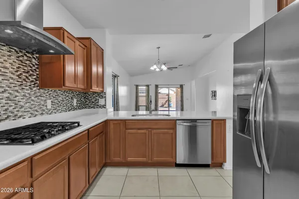 a kitchen with stainless steel appliances granite countertop a stove a sink dishwasher and refrigerator