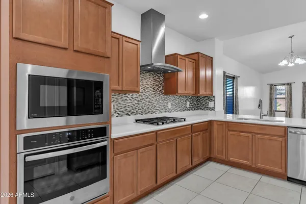 a kitchen with granite countertop cabinets stainless steel appliances and a sink