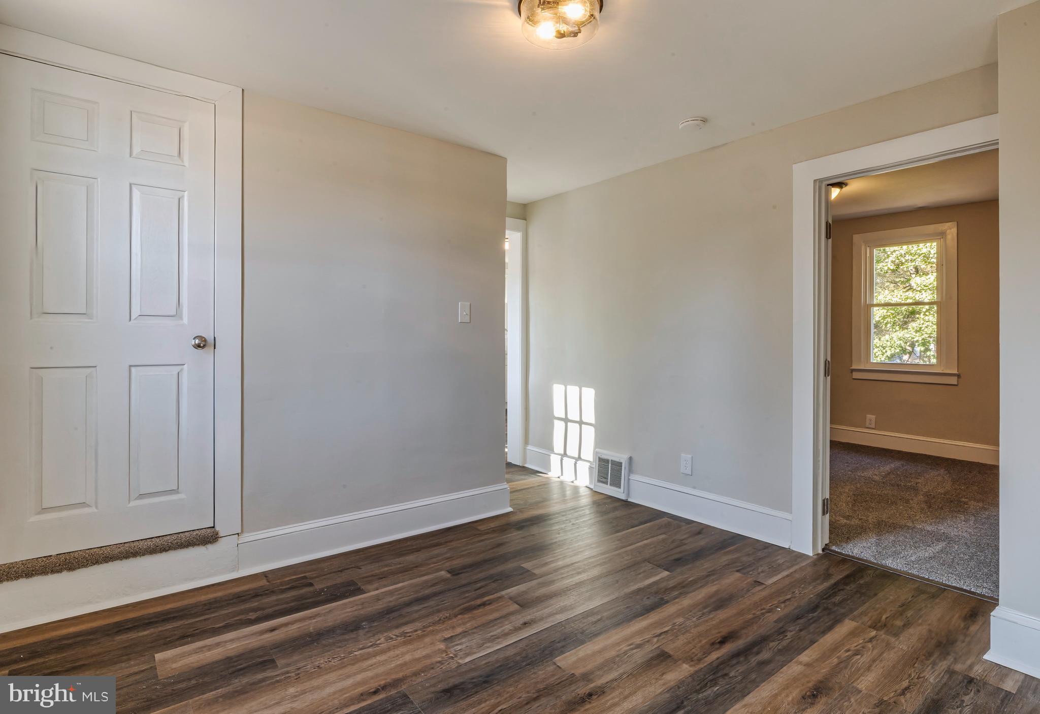 14 Forrest Avenue Clementon, NJ 08021 - Photo 11 of 20 a view of an empty room with wooden floor and a window