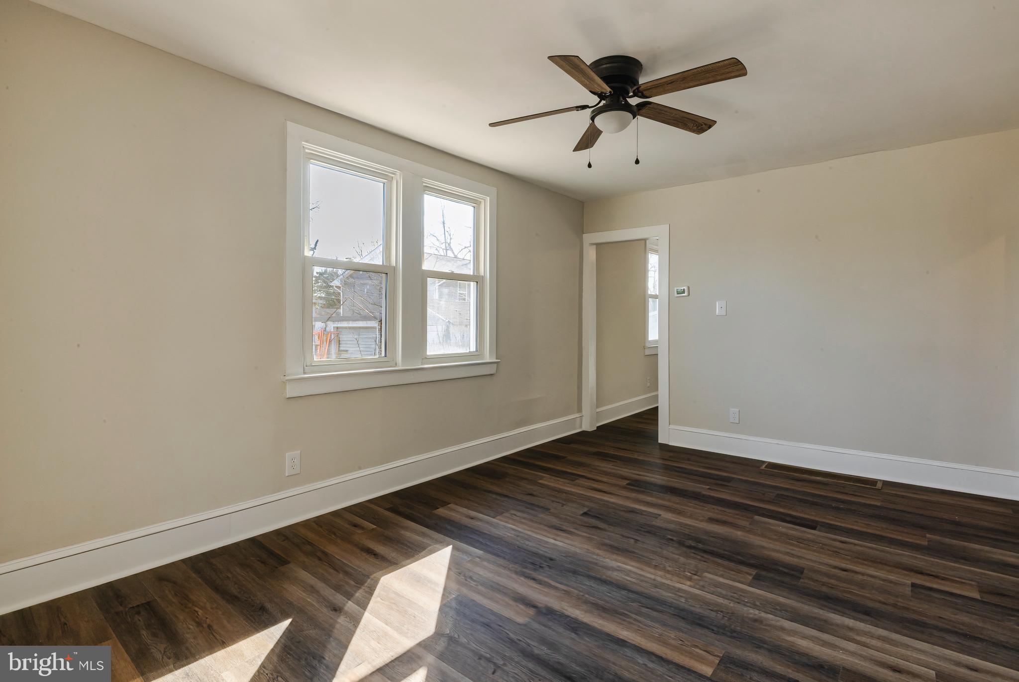 14 Forrest Avenue Clementon, NJ 08021 - Photo 4 of 20 a view of an empty room with wooden floor and a window