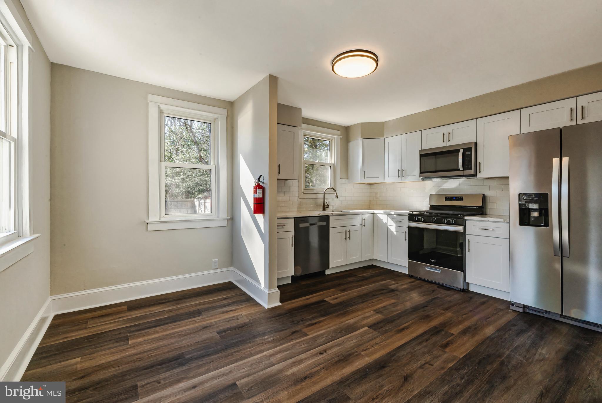 14 Forrest Avenue Clementon, NJ 08021 - Photo 7 of 20 a kitchen with a refrigerator and a stove top oven