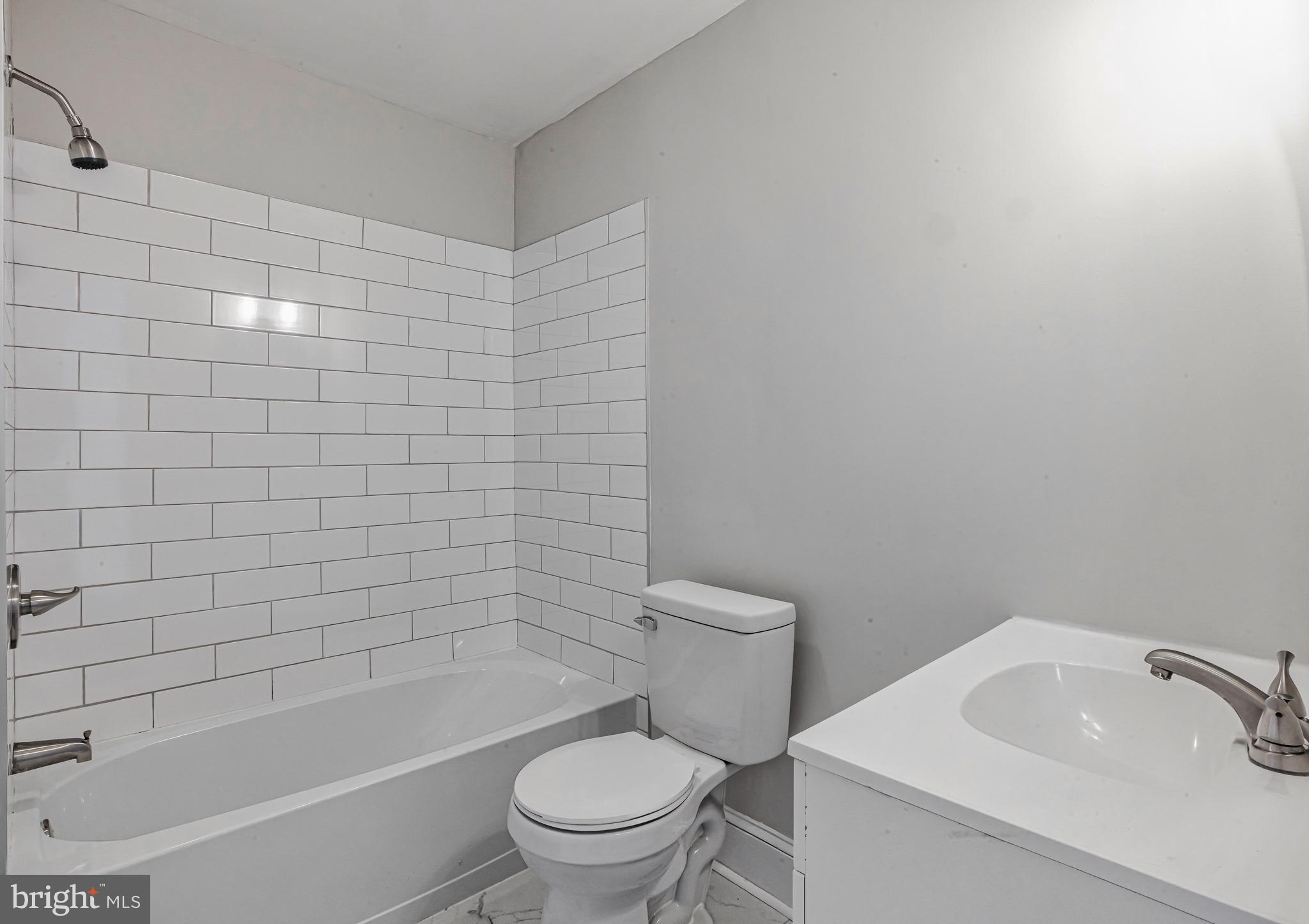 14 Forrest Avenue Clementon, NJ 08021 - Photo 8 of 20 a white toilet sitting next to a bath tub