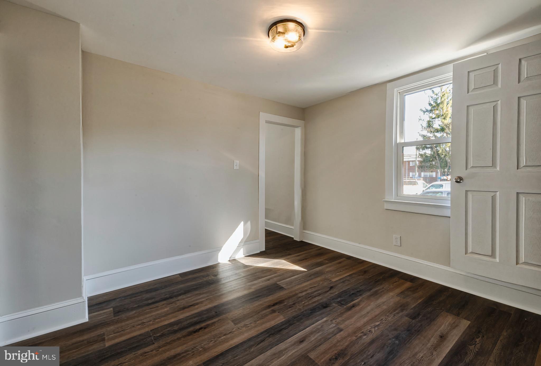 14 Forrest Avenue Clementon, NJ 08021 - Photo 9 of 20 a view of an empty room with wooden floor and a window
