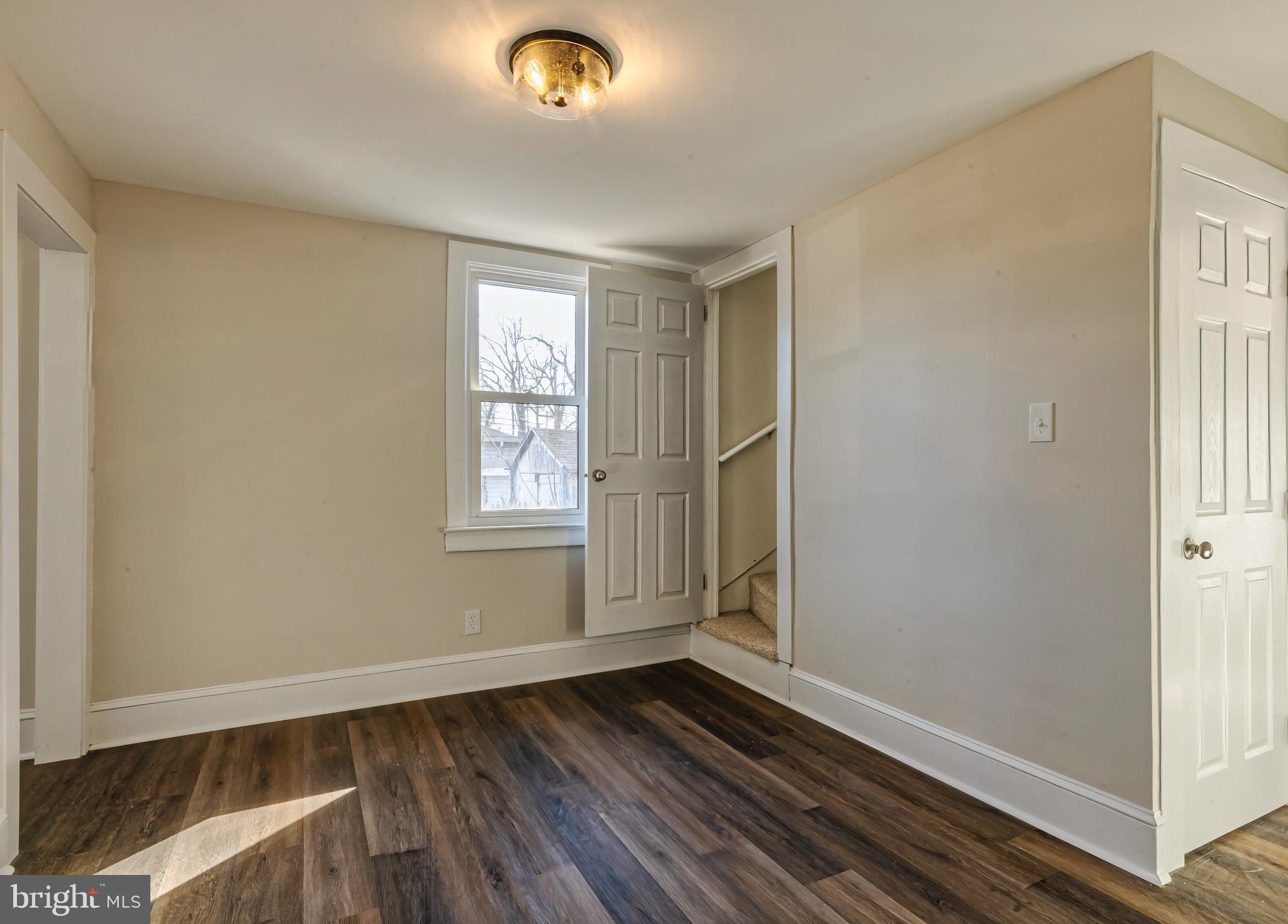 14 Forrest Avenue Clementon, NJ 08021 - Photo 10 of 20 an empty room with wooden floor and windows