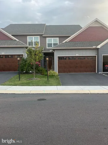 a view of a house with a yard and garage