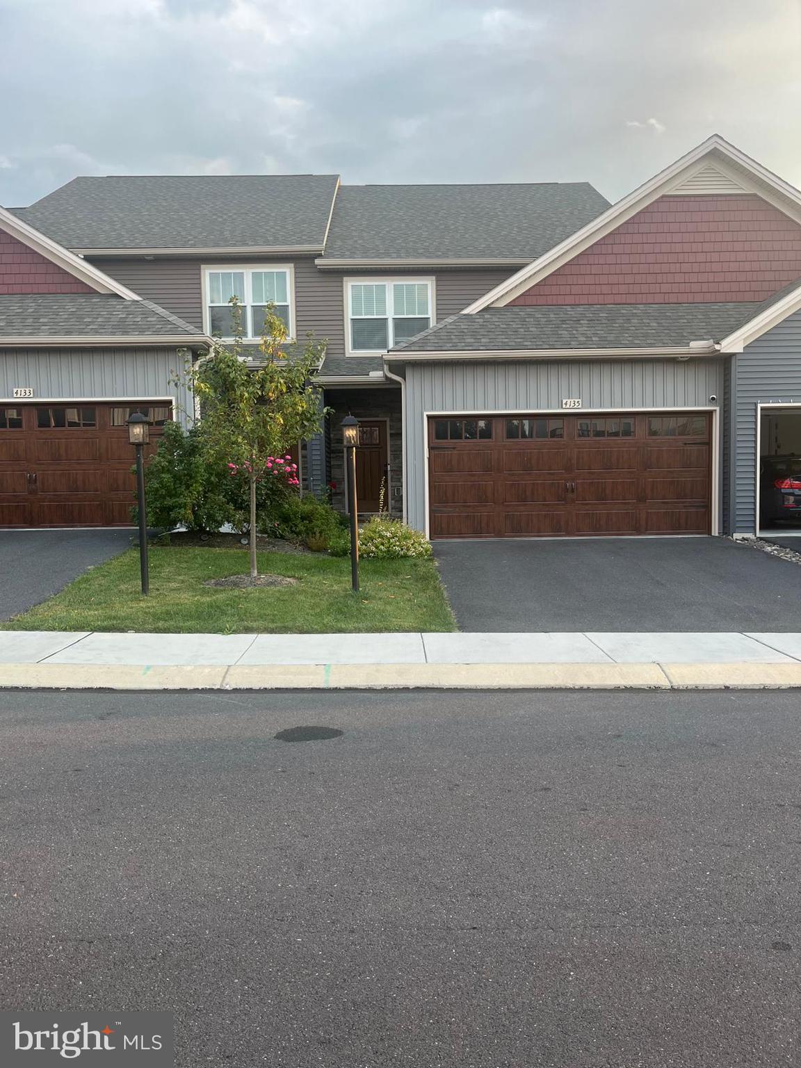 4135 Orrs Town Court, Unit 4B Mechanicsburg, PA 17050 - Photo 1 of 49 a view of a house with a yard and garage