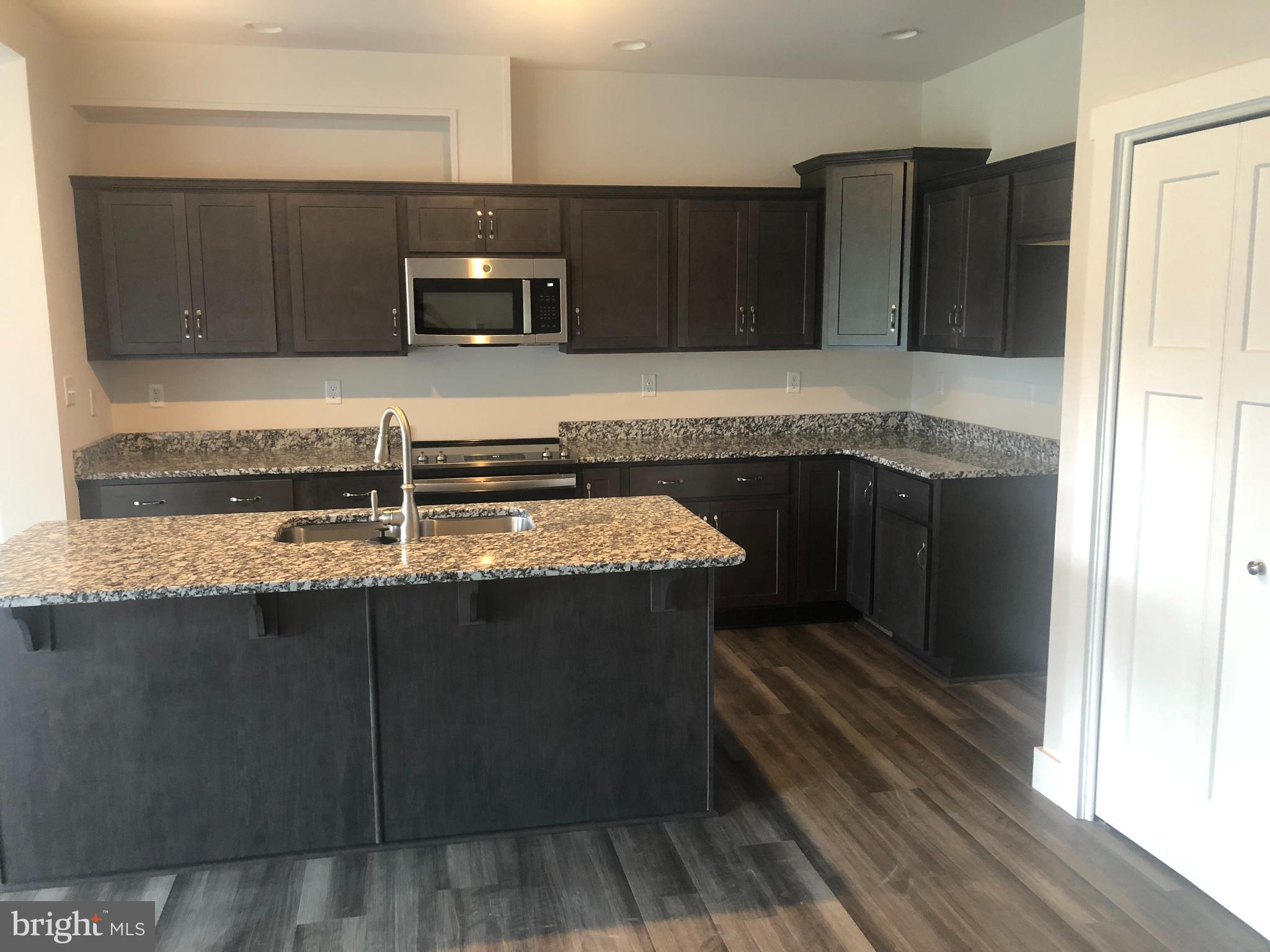 4135 Orrs Town Court, Unit 4B Mechanicsburg, PA 17050 - Photo 15 of 49 a kitchen with a sink and a microwave