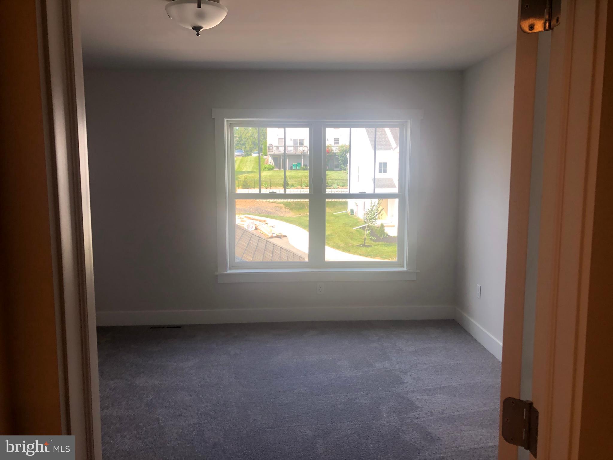 4135 Orrs Town Court, Unit 4B Mechanicsburg, PA 17050 - Photo 37 of 49 an empty room with windows