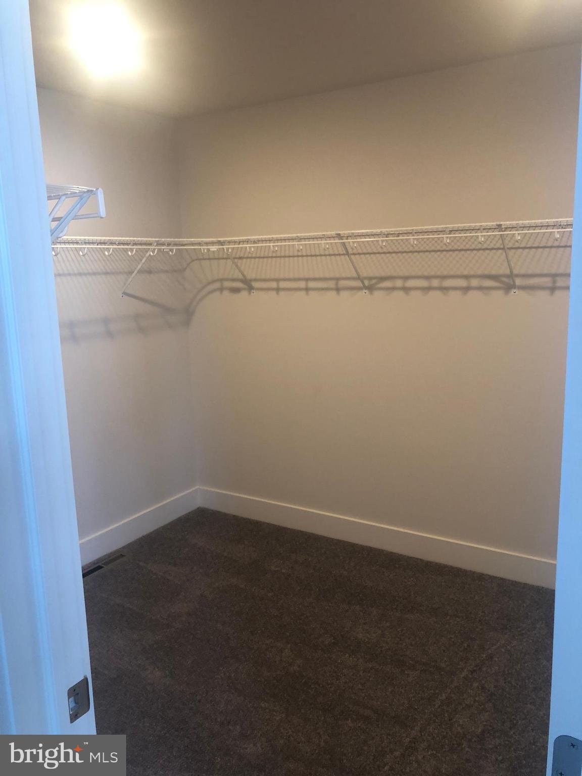 4135 Orrs Town Court, Unit 4B Mechanicsburg, PA 17050 - Photo 40 of 49 a view of a room with racks on the wall