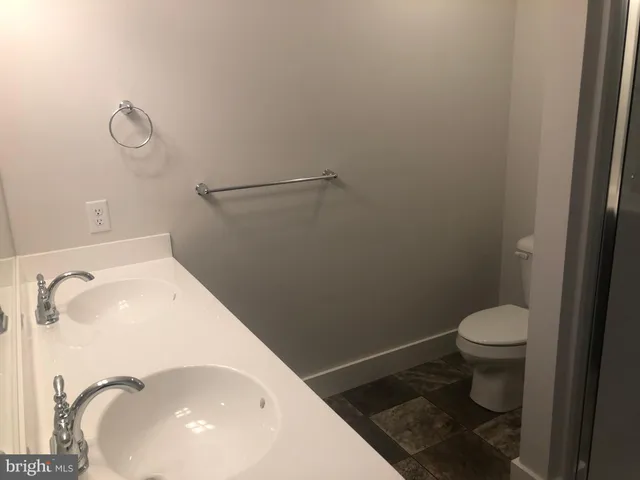 a view of a field with trees in background