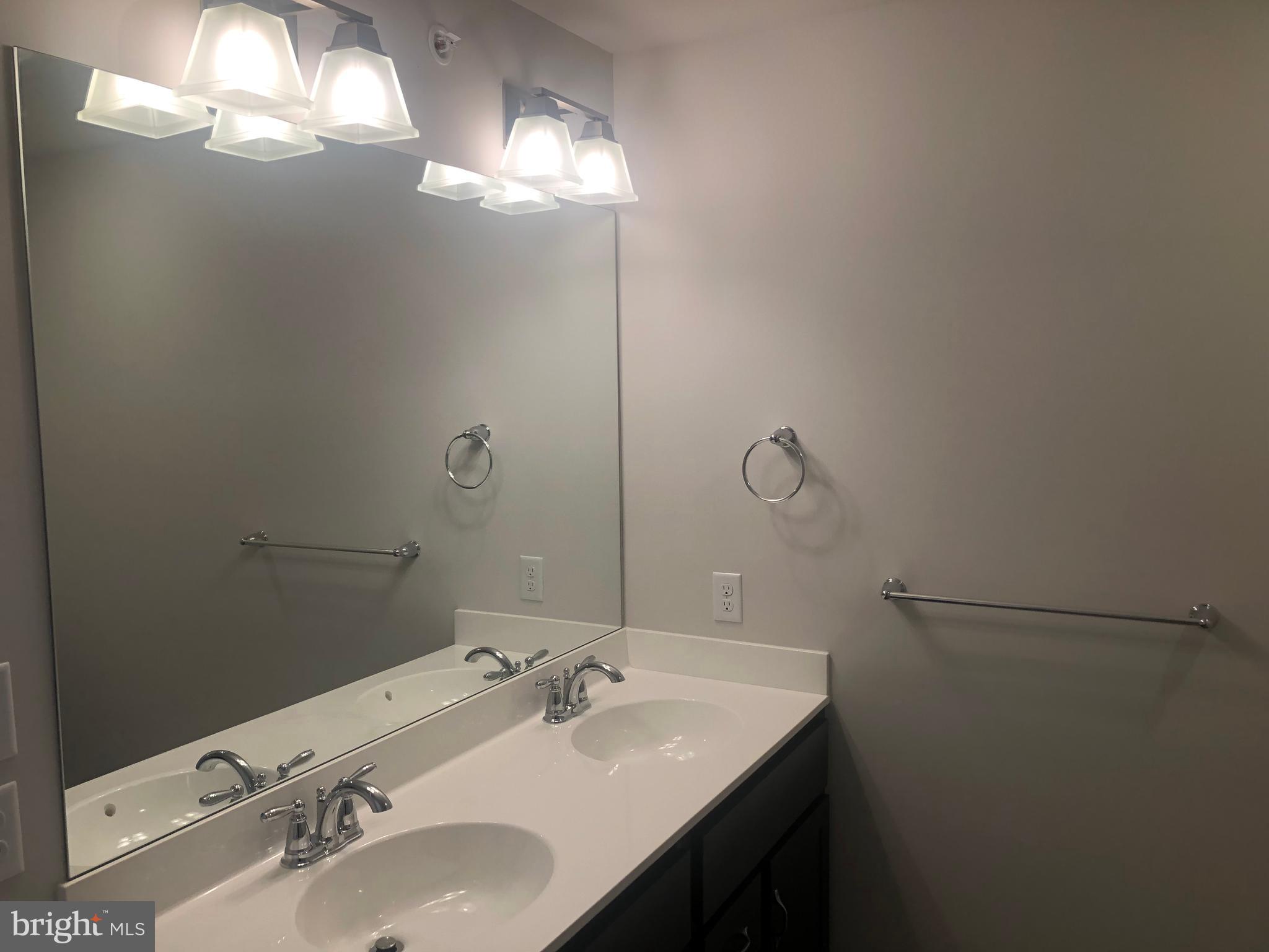 4135 Orrs Town Court, Unit 4B Mechanicsburg, PA 17050 - Photo 43 of 49 a bathroom with a sink and a mirror