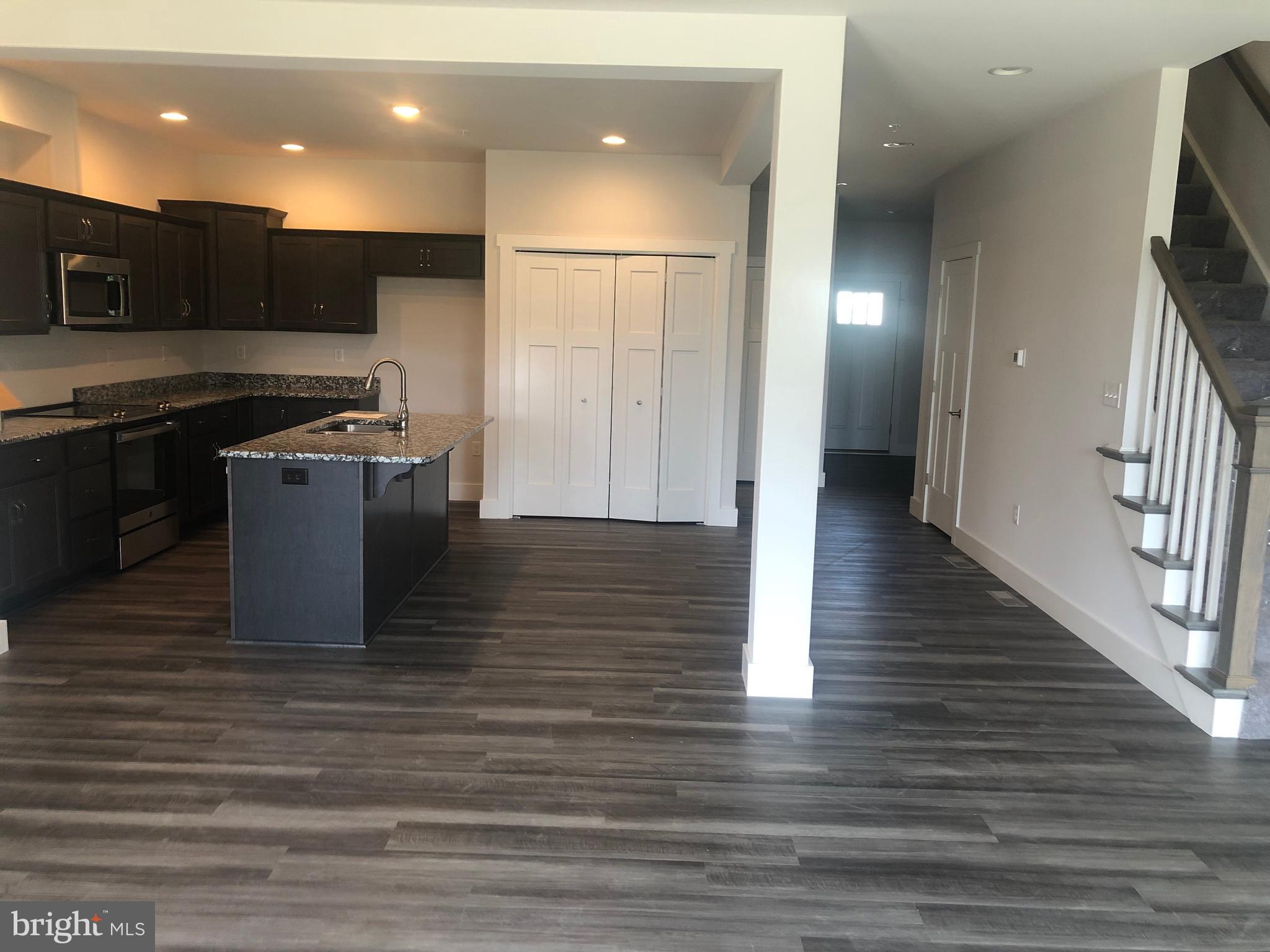 4135 Orrs Town Court, Unit 4B Mechanicsburg, PA 17050 - Photo 47 of 49 a kitchen with stainless steel appliances granite countertop a refrigerator a sink and a stove