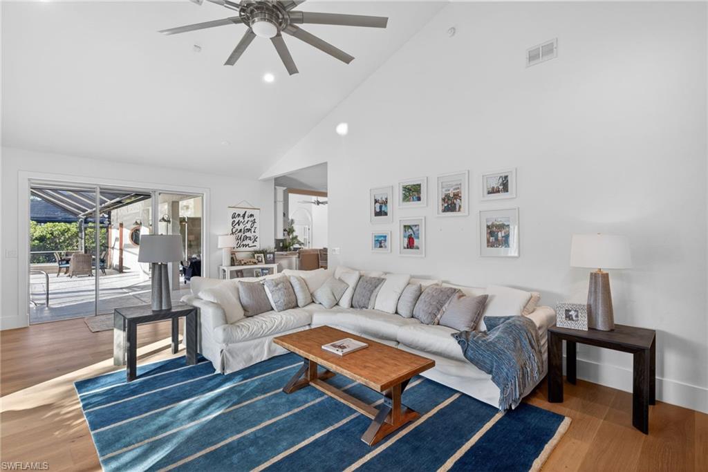 7657 Ponte Verde Way Naples, FL 34109 - Photo 15 of 41 a living room with furniture and wooden floor