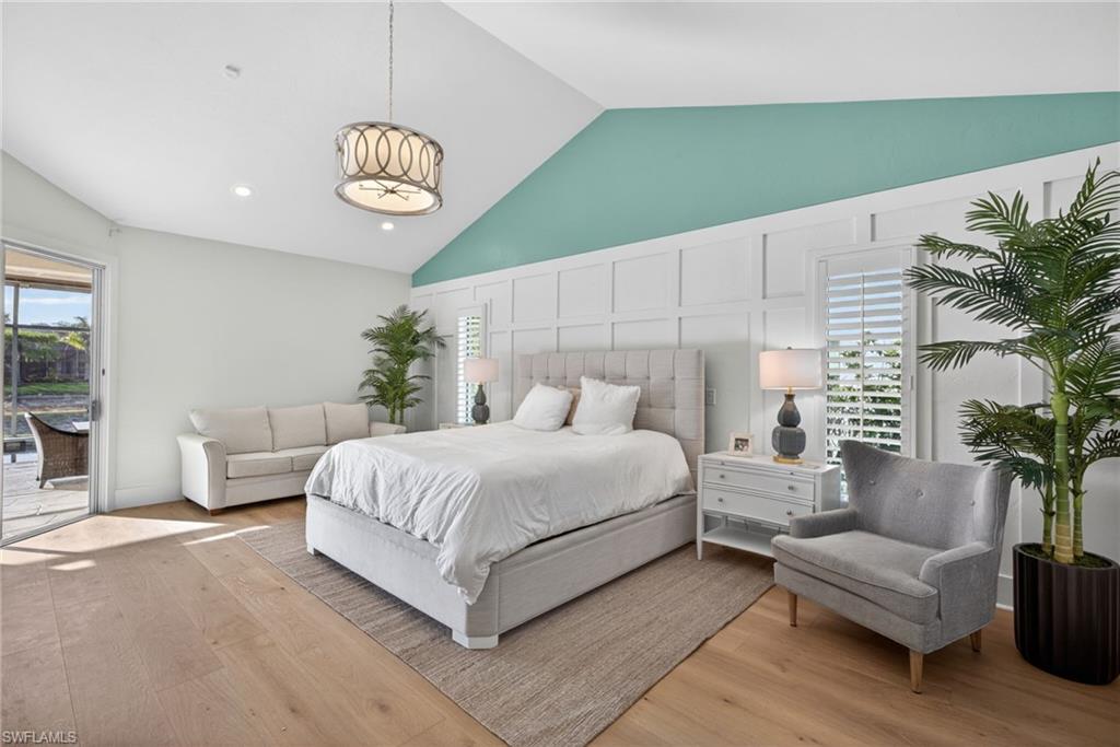 7657 Ponte Verde Way Naples, FL 34109 - Photo 17 of 41 a spacious bedroom with a bed and a table