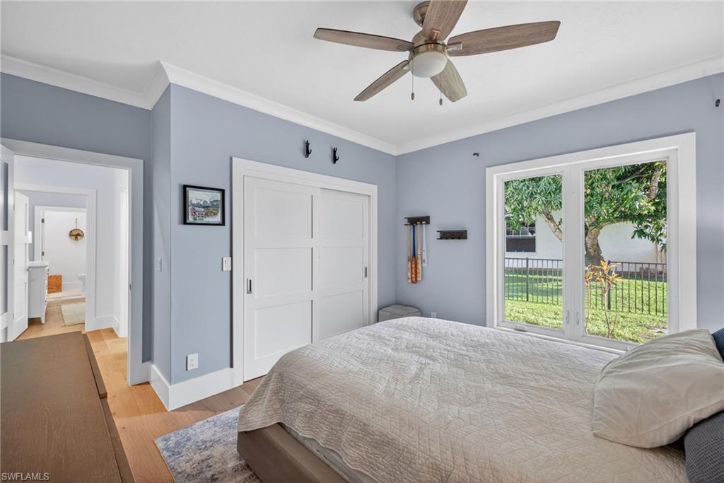 7657 Ponte Verde Way Naples, FL 34109 - Photo 20 of 41 a bedroom with a large bed and ceiling fan