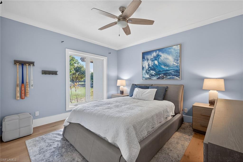 7657 Ponte Verde Way Naples, FL 34109 - Photo 23 of 41 a bedroom with a large bed and a window
