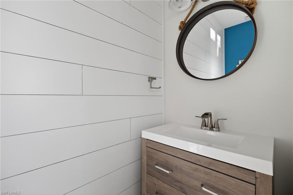 7657 Ponte Verde Way Naples, FL 34109 - Photo 24 of 41 a bathroom with a sink and a mirror