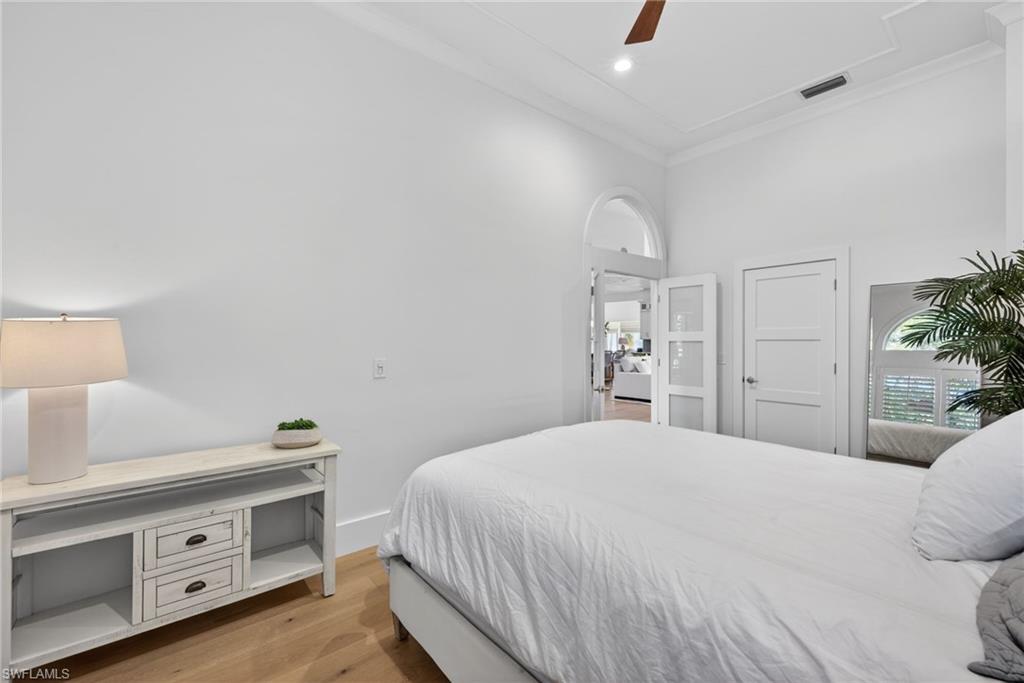 7657 Ponte Verde Way Naples, FL 34109 - Photo 26 of 41 a bedroom with a bed and a dresser