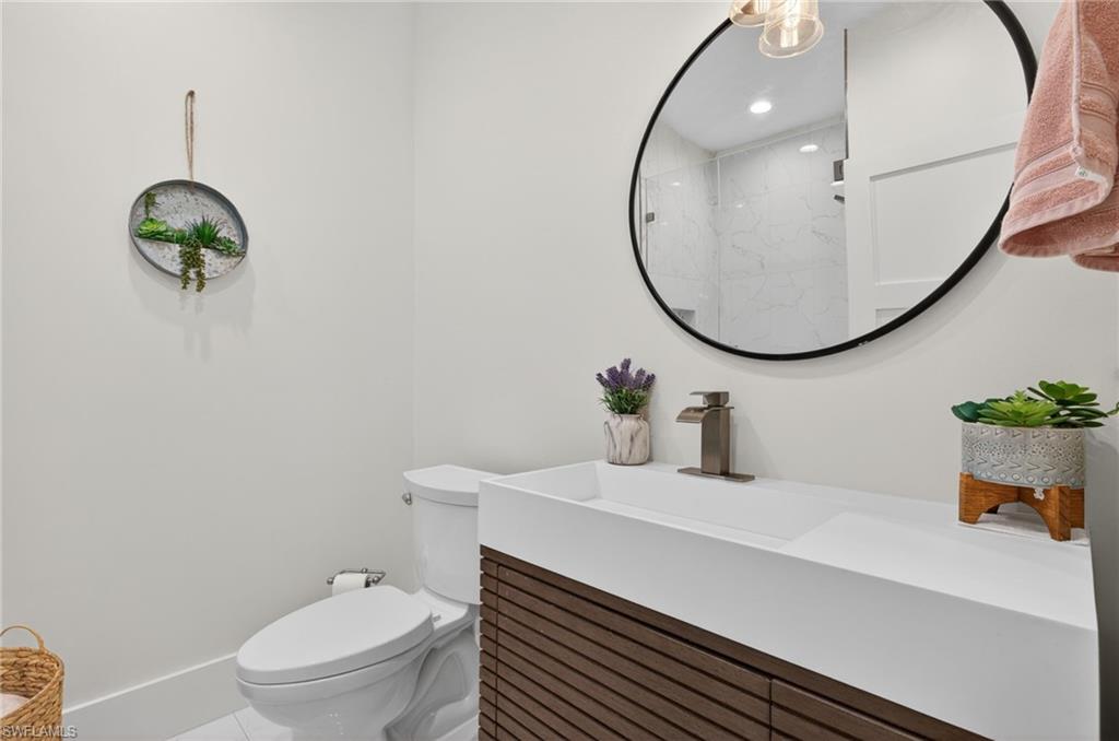 7657 Ponte Verde Way Naples, FL 34109 - Photo 27 of 41 a bathroom with a sink mirror and toilet