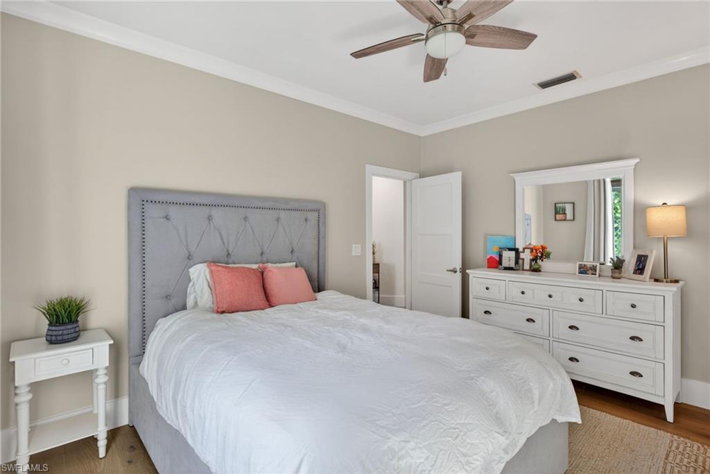 7657 Ponte Verde Way Naples, FL 34109 - Photo 28 of 41 a bedroom with a bed and a dresser