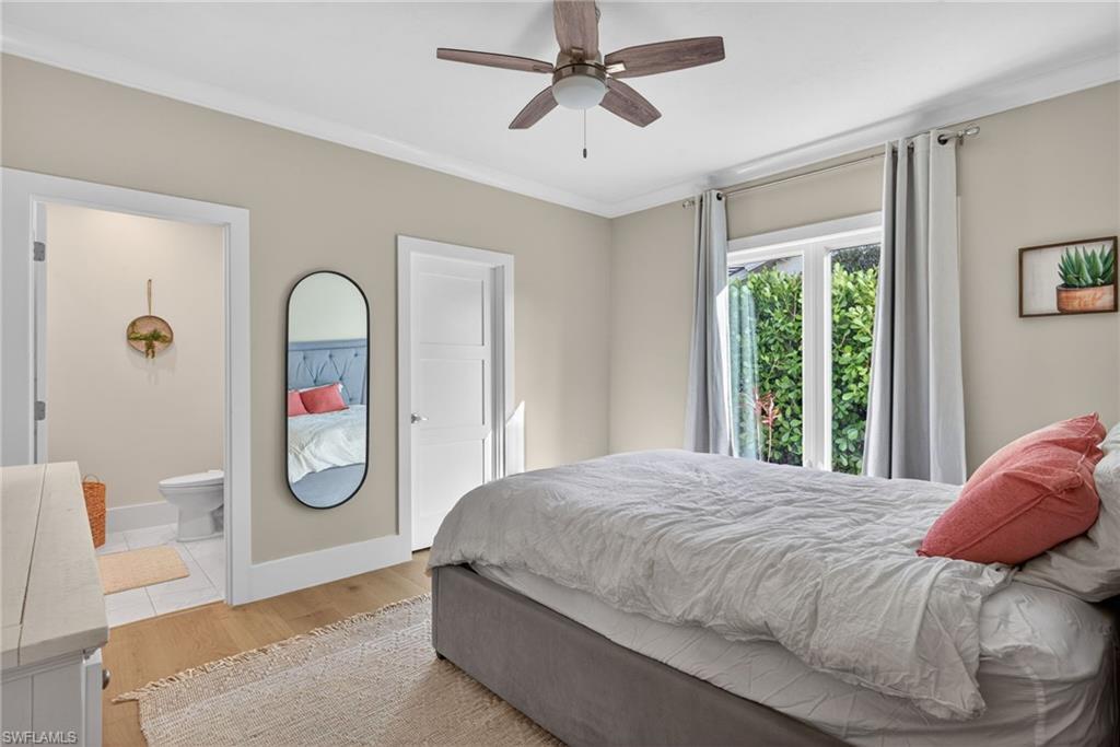 7657 Ponte Verde Way Naples, FL 34109 - Photo 29 of 41 a bedroom with a large bed and a chandelier