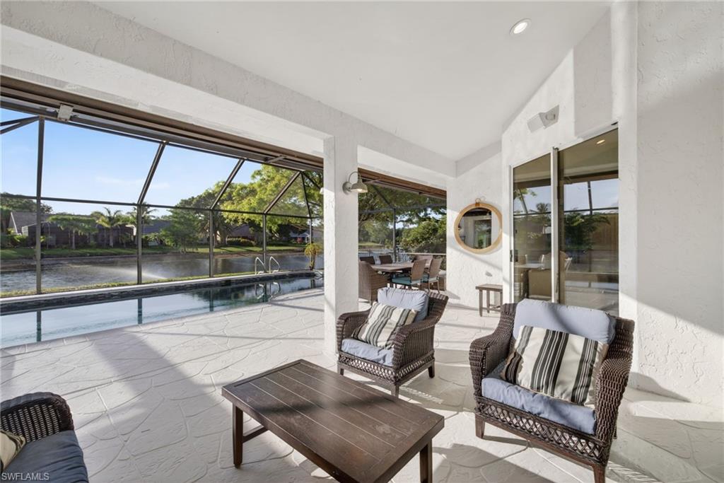 7657 Ponte Verde Way Naples, FL 34109 - Photo 32 of 41 a living room with furniture and a large window