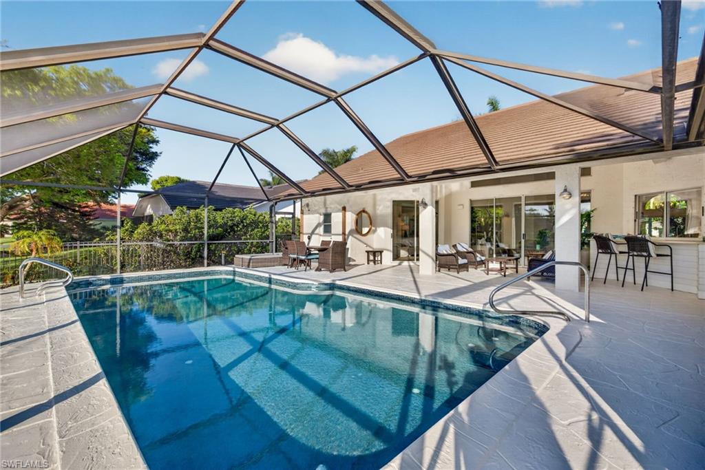 7657 Ponte Verde Way Naples, FL 34109 - Photo 35 of 41 a view of a swimming pool with a patio