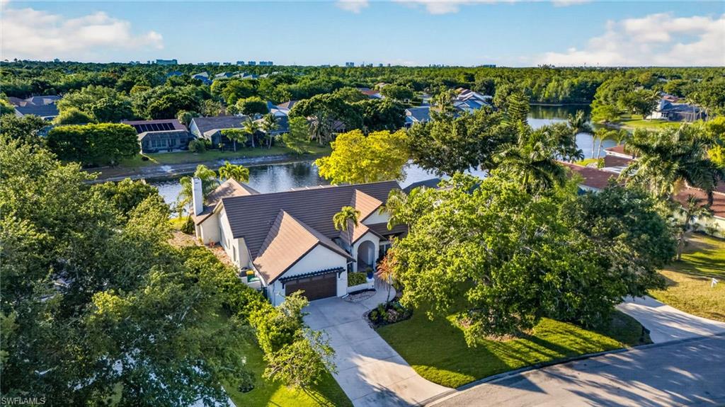 7657 Ponte Verde Way Naples, FL 34109 - Photo 39 of 41 an aerial view of a house with a yard and lake view
