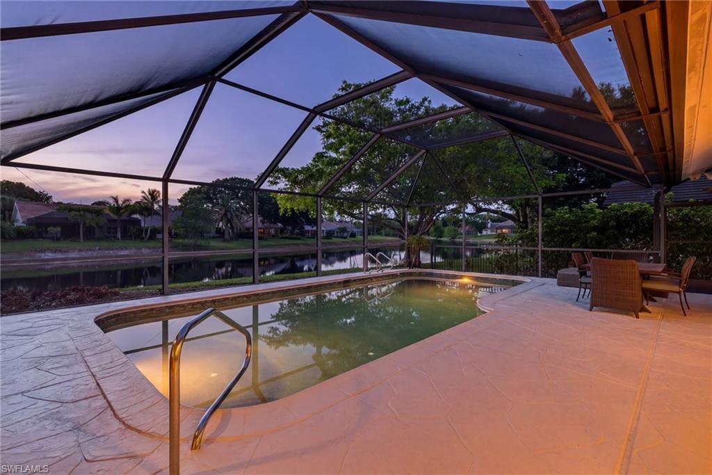 7657 Ponte Verde Way Naples, FL 34109 - Photo 4 of 41 a view of a swimming pool with a patio
