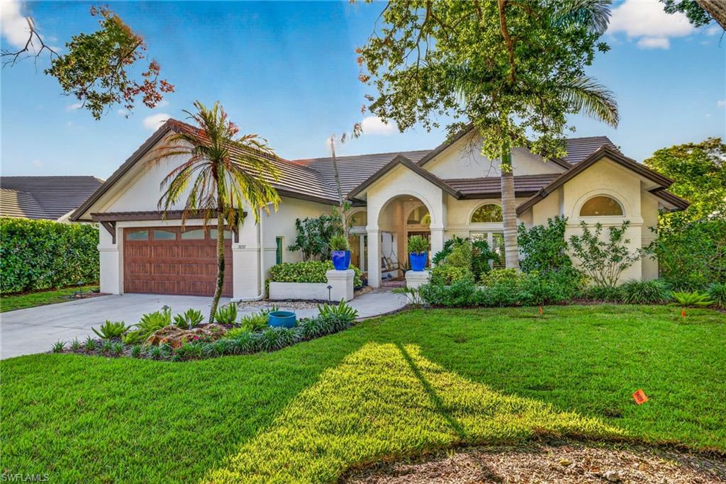 7657 Ponte Verde Way Naples, FL 34109 - Photo 6 of 41 a front view of a house with a garden
