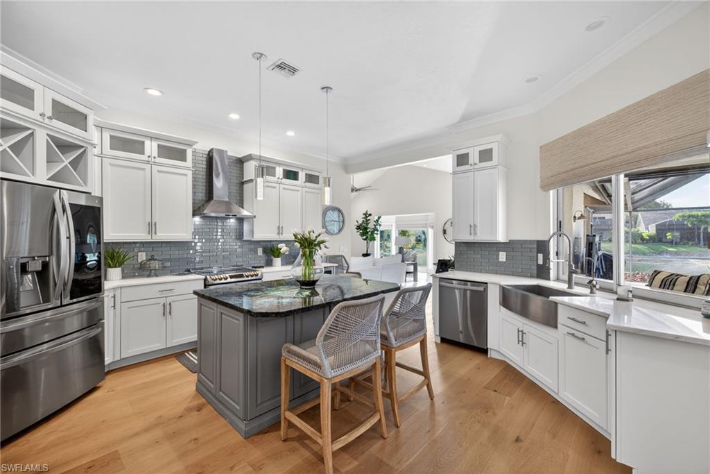 7657 Ponte Verde Way Naples, FL 34109 - Photo 9 of 41 a kitchen with a sink and stove