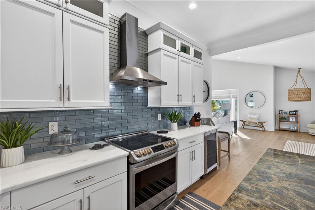 7657 Ponte Verde Way Naples, FL 34109 - Photo 10 of 41 a kitchen with stainless steel appliances white cabinets and a stove