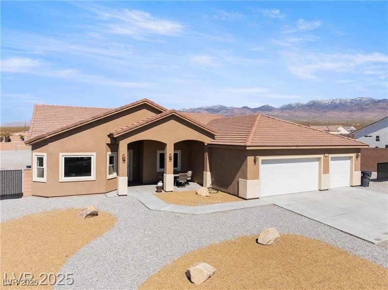 760 Fort Churchill Road Pahrump, NV 89060 - Photo 1 of 33 View of front facade with concrete driveway, stucco siding, a garage, and a tiled roof