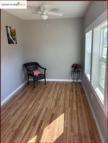 a room with wooden floor and a window