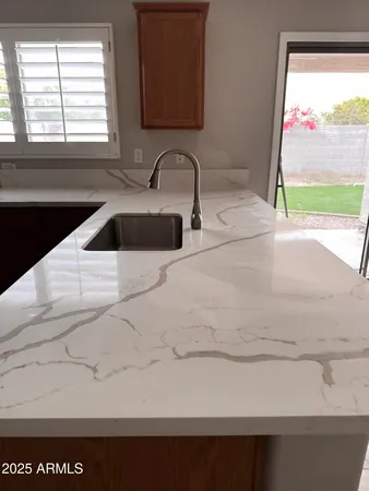a kitchen with a sink and a large window